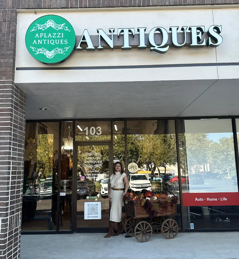 Aplazzi Antiques store front with owner Paz Schroeder standing outside.